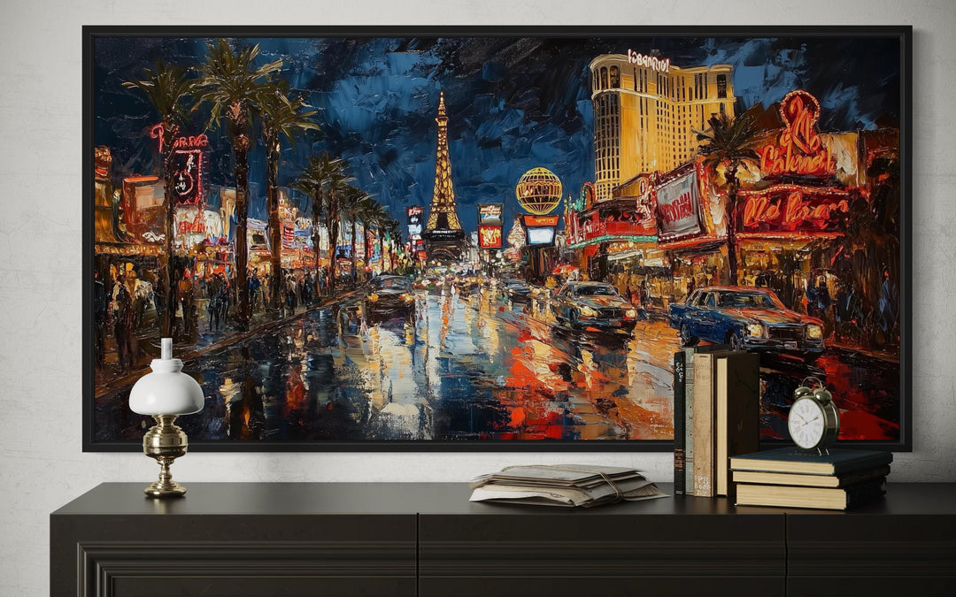 Impressionist oil painting of the Las Vegas Strip at night, framed and displayed above a sideboard.