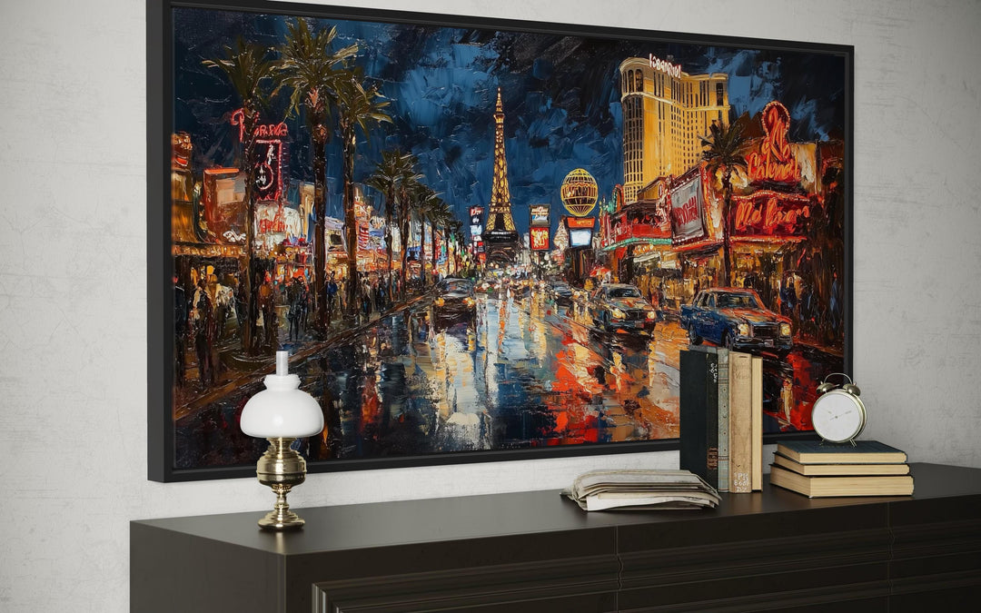 Impressionist oil painting of the Las Vegas Strip at night on a framed canvas above a dresser.