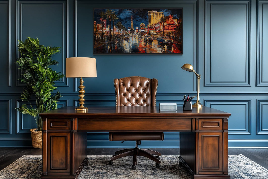 Las Vegas Strip At Night Framed Canvas Wall Art hanging in a dark blue office above a wooden desk.