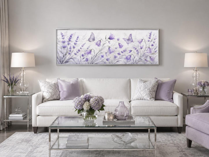 Long horizontal canvas wall art featuring lavender wildflowers and butterflies above a white sofa.