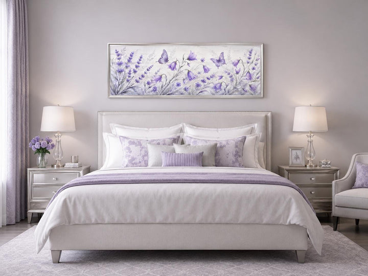 Long horizontal canvas wall art featuring lavender wildflowers and butterflies above a bed.