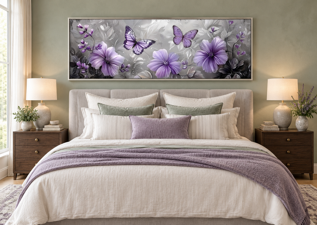 Horizontal wall art with lavender flowers and butterflies above a bed in a sage green room.
