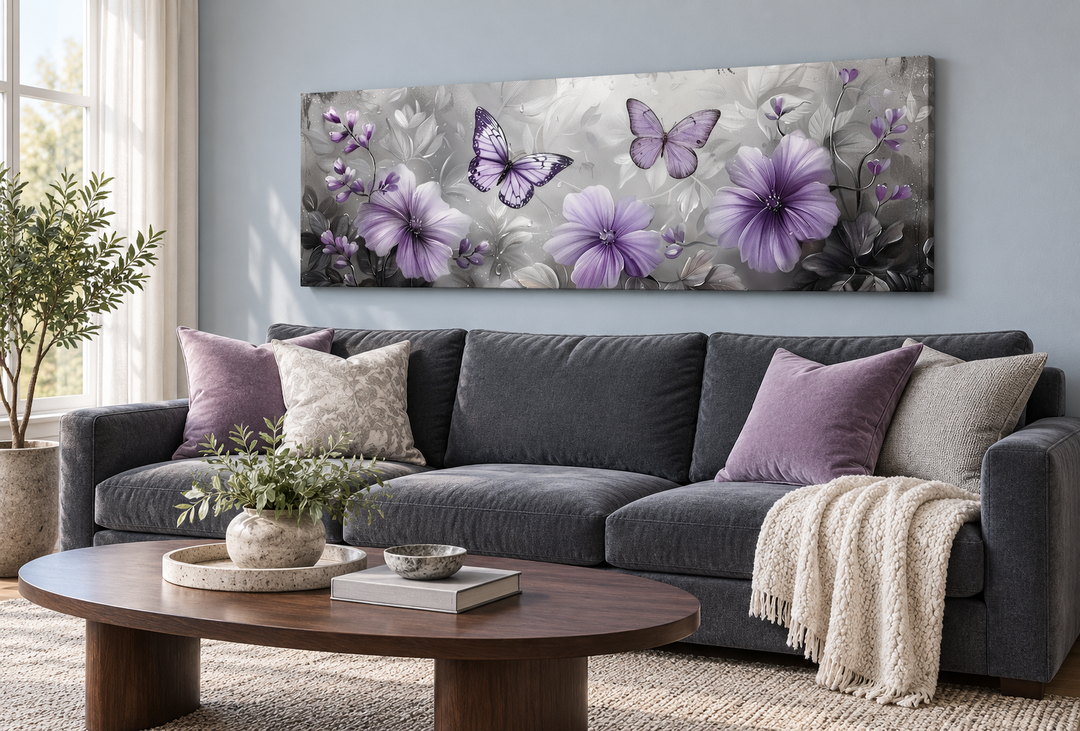 Horizontal wall art of purple flowers and butterflies above a gray sofa in a modern living room.
