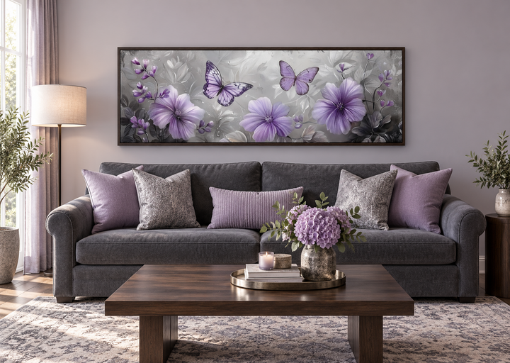 Lavender purple floral and butterfly horizontal wall art in a dark frame above a gray sofa.