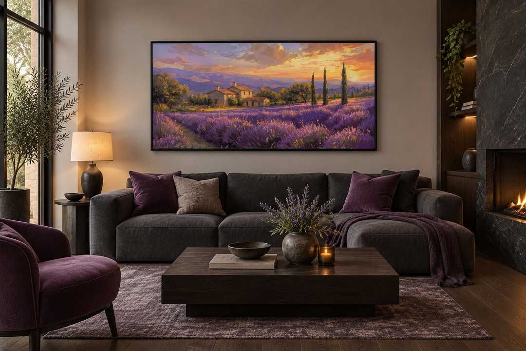 Framed canvas wall art of a sunset over lavender fields in Provence above a dark grey sofa.