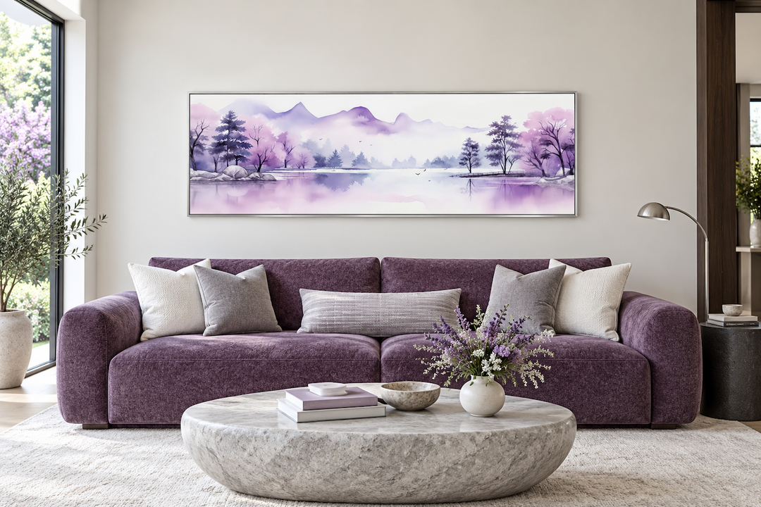 Long horizontal watercolor painting of purple mountains and a lake above a purple sofa.