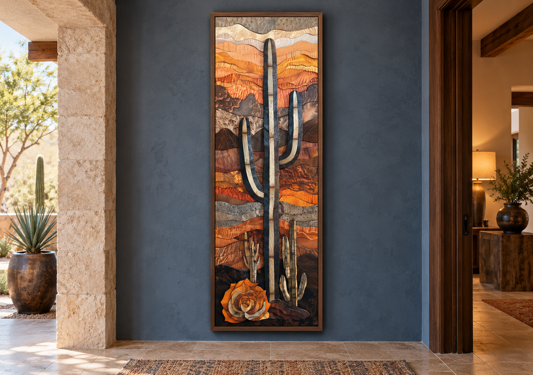 Vertical framed canvas wall art of a saguaro cactus in a layered wood style on a blue wall.