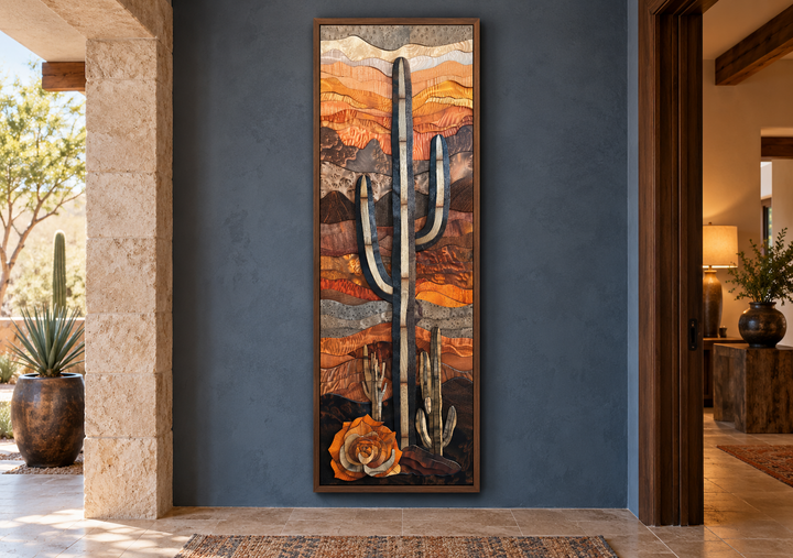 Vertical framed canvas wall art of a saguaro cactus in a layered wood style on a blue wall.