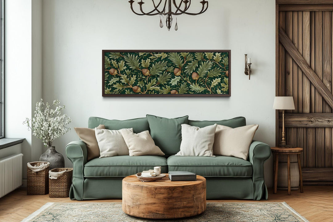 A long horizontal canvas of William Morris style leaves and acorns hangs above a green sofa.