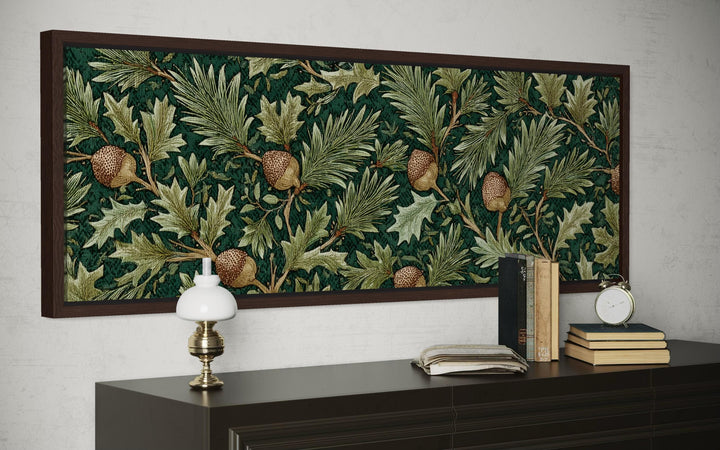 William Morris style horizontal wall art with green oak leaves and acorns above a dark sideboard.