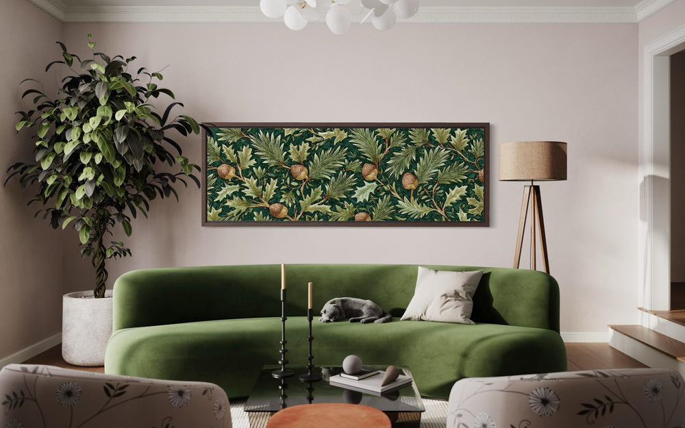 William Morris style horizontal wall art with green leaves and acorns above a green velvet sofa.