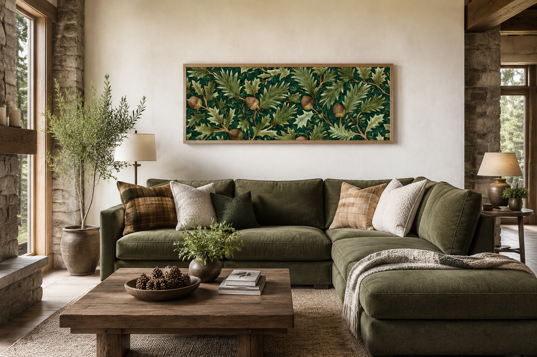 William Morris style horizontal wall art with green leaves and acorns above a green velvet sofa.