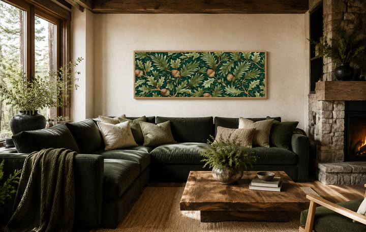 William Morris style horizontal canvas art with green oak leaves and acorns above a green sofa.