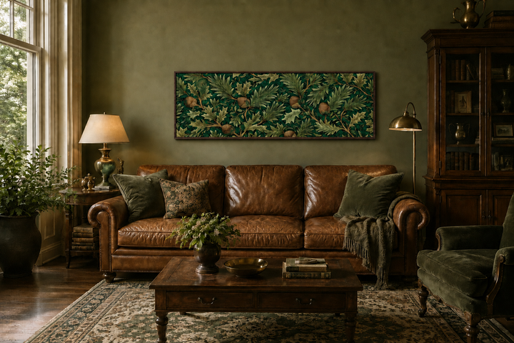 William Morris style horizontal canvas art with green oak leaves and acorns above a leather sofa.