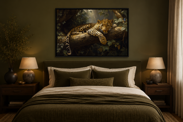 Framed canvas wall art of a leopard resting on a tree branch in a jungle above a bed.