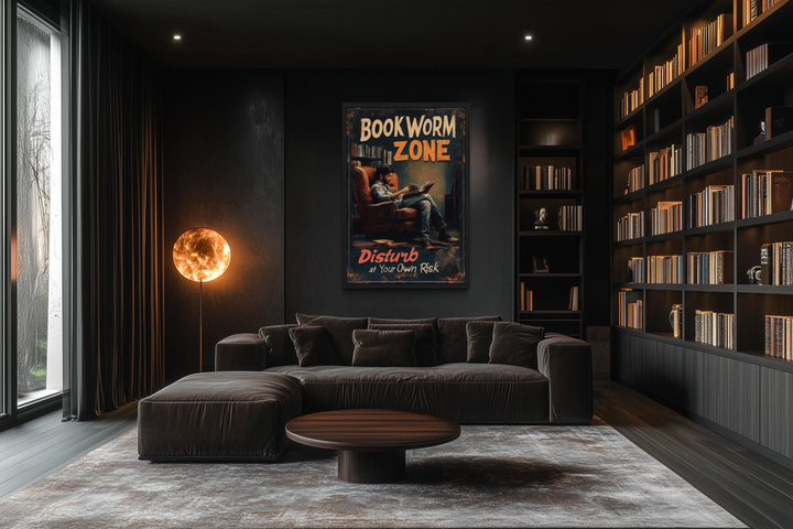 Bookworm Zone canvas print hanging in a dark, modern library with a large sofa and bookshelves.