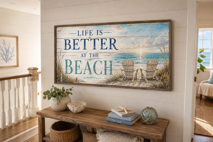 Life Is Better at the Beach canvas sign with ocean view and beach chairs on a shiplap wall.