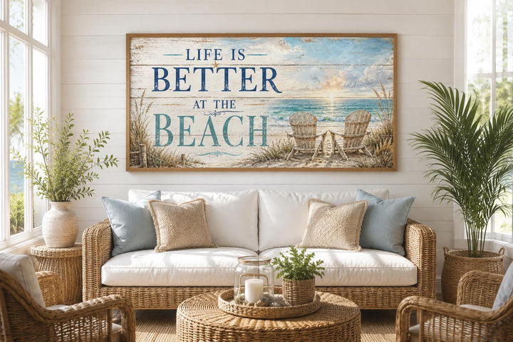 Life Is Better at the Beach coastal wall art hanging above a white sofa with rattan furniture.