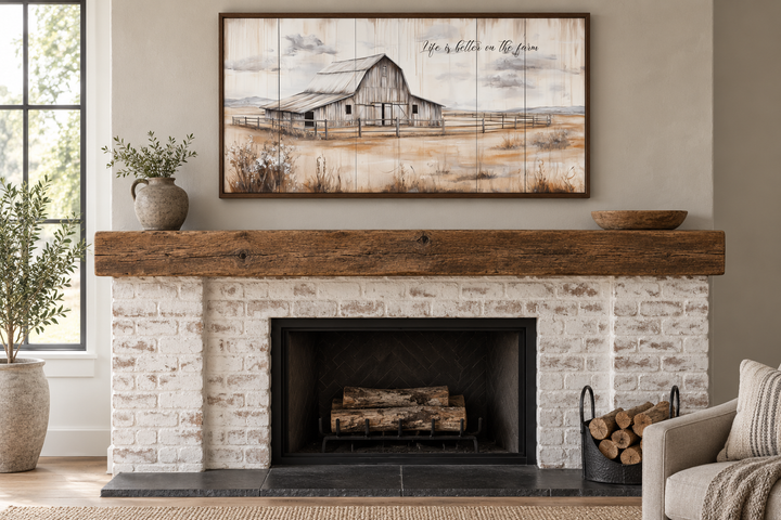 Rustic farmhouse canvas wall art of a weathered barn above a white brick fireplace mantel.