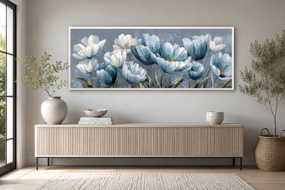 Light blue abstract floral wall art in a white frame above a modern wooden sideboard.