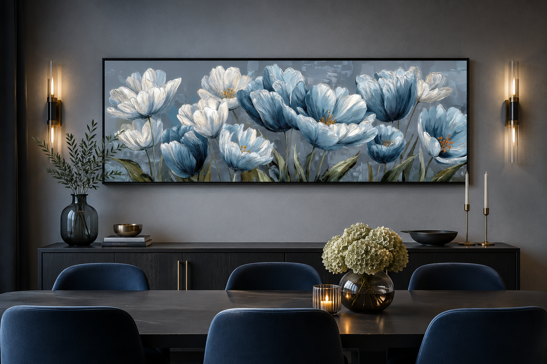 Light blue abstract floral horizontal wall art above a dining table with blue velvet chairs.