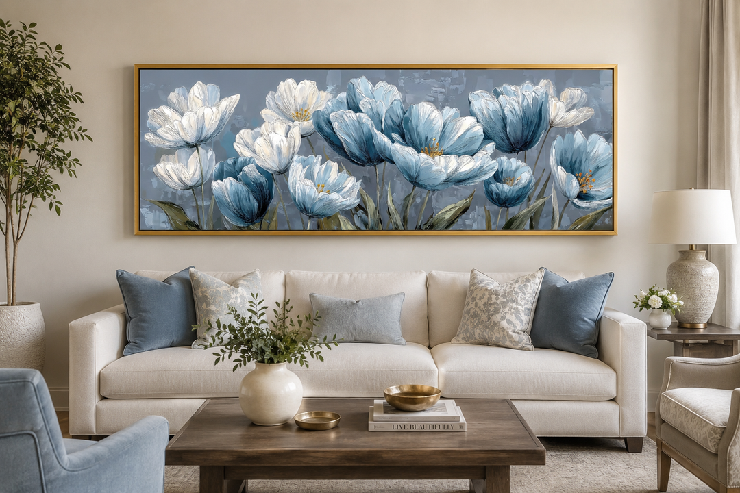 Light blue abstract floral horizontal wall art in a gold frame above a white sofa.