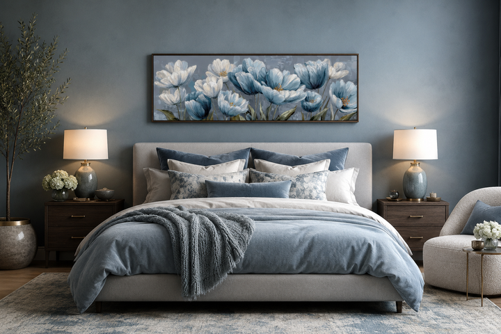 Long horizontal wall art with light blue abstract flowers in a frame above a bed.