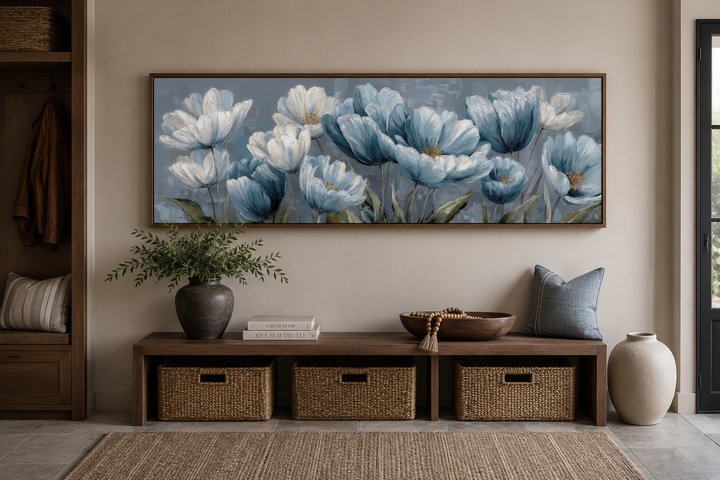 Long horizontal wall art featuring light blue abstract flowers in a brown frame above a bench.
