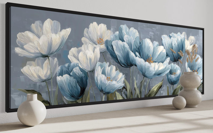 Long horizontal wall art featuring light blue and white abstract flowers in a black frame.