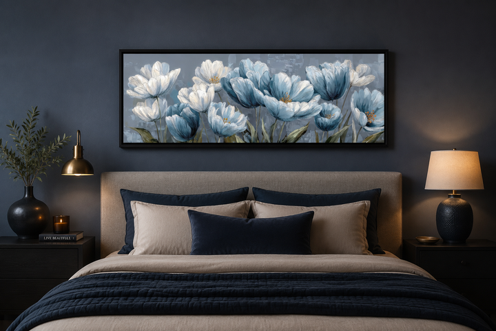 Long horizontal wall art of light blue and white abstract flowers above a bed in a dark room.