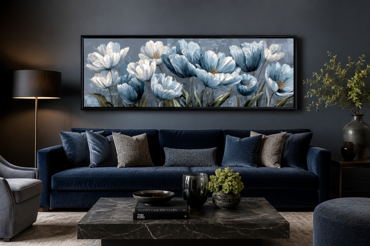 Light blue abstract flowers long horizontal wall art displayed above a dark blue velvet couch.
