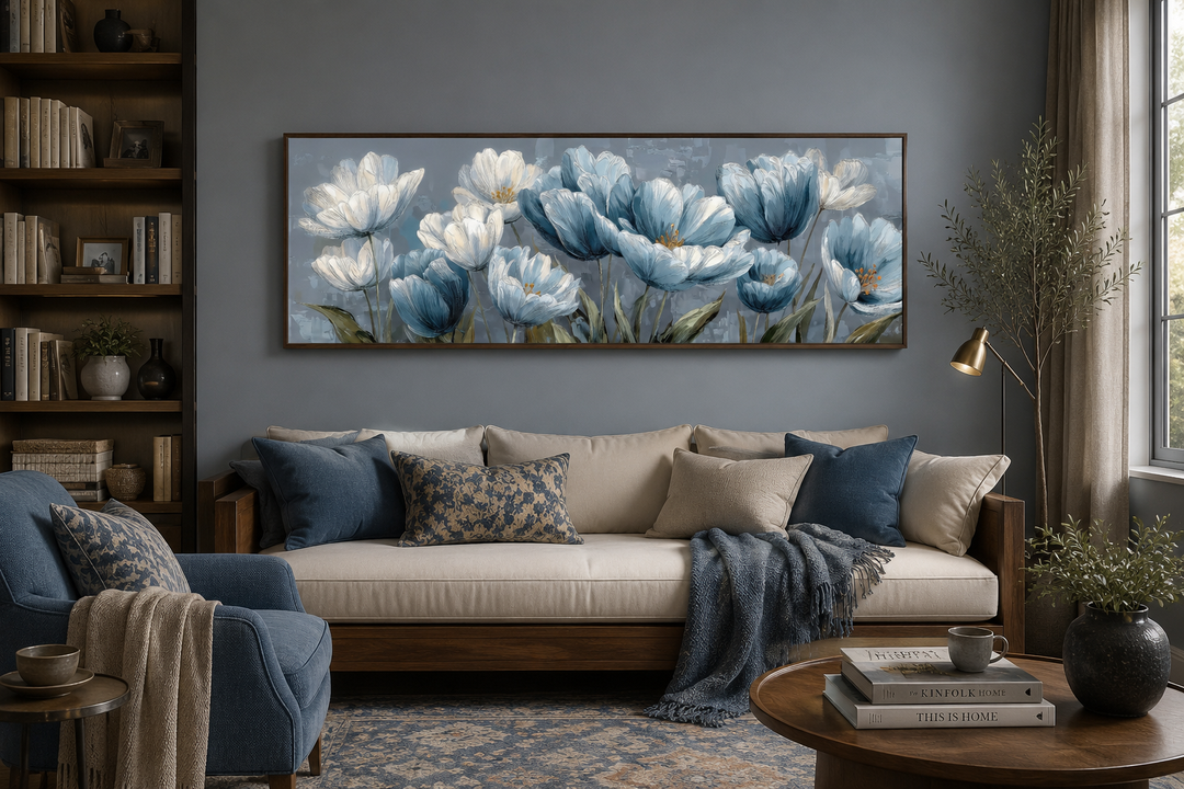 Long horizontal wall art of light blue abstract flowers above a beige sofa in a modern living room.