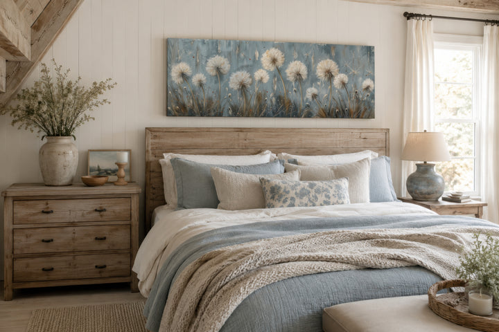 Horizontal framed canvas wall art featuring light blue dandelions and butterflies above a bed.