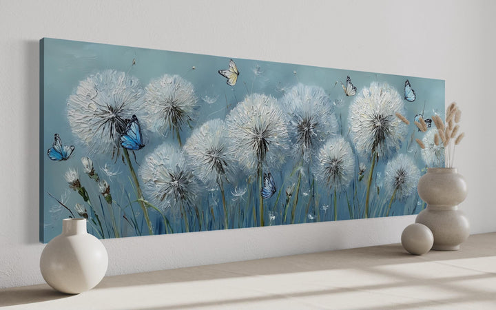 Horizontal framed canvas wall art featuring textured white dandelions and blue butterflies.