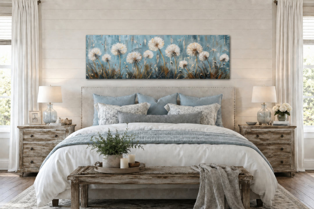 Horizontal framed canvas wall art featuring light blue dandelions and butterflies above a bed.