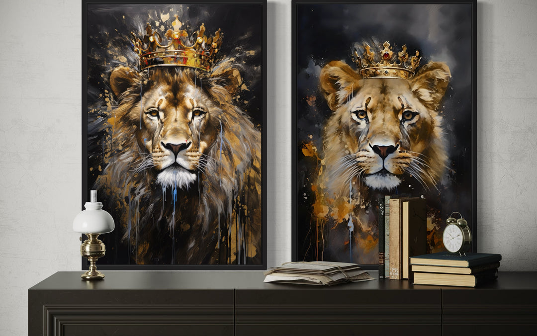 Set of two framed canvas prints featuring a lion and lioness wearing gold crowns on black backgrounds