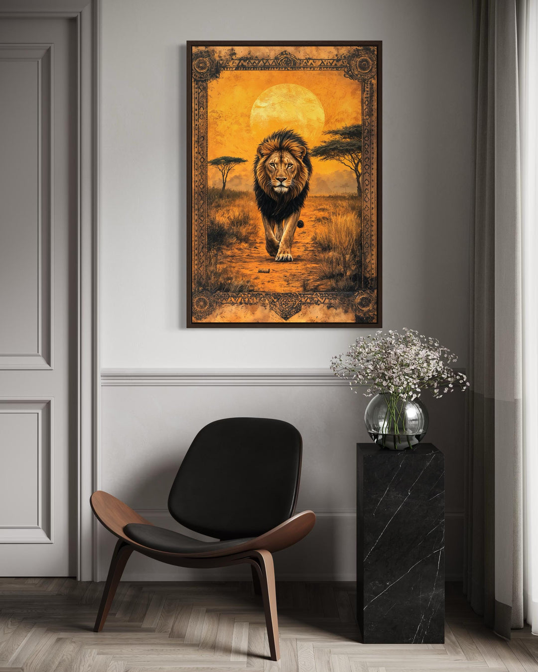 A framed canvas wall art of a lion walking in the African savanna at sunset above a modern chair.