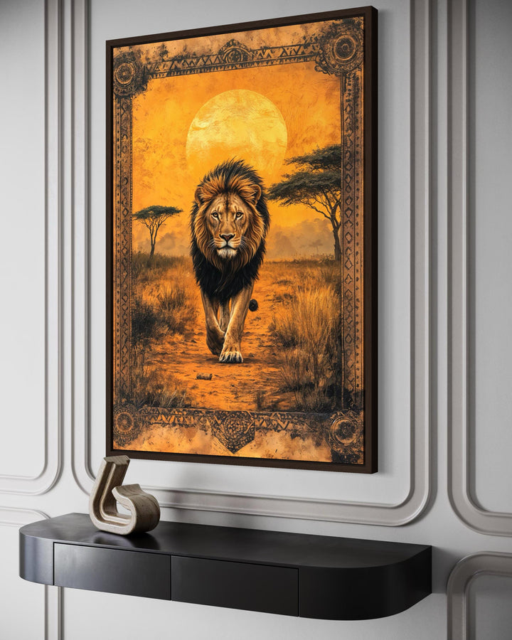 Lion in African savanna at sunset canvas wall art featuring a lion walking through golden grass.