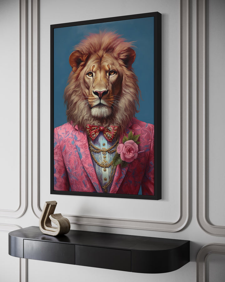 Lion in a pink suit maximalist framed canvas wall art hanging above a black console table.