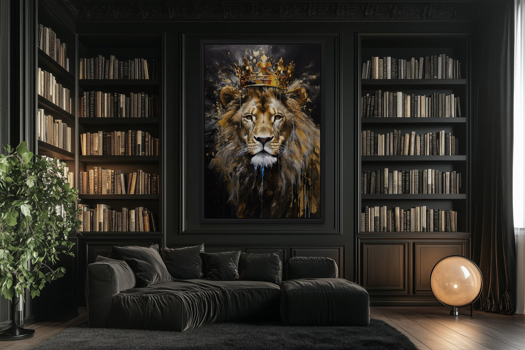 Framed canvas wall art of a lion wearing a gold crown in a dark library with a black sofa.