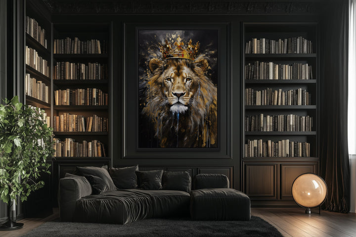 Framed canvas wall art of a lion wearing a gold crown in a dark library with a black sofa.