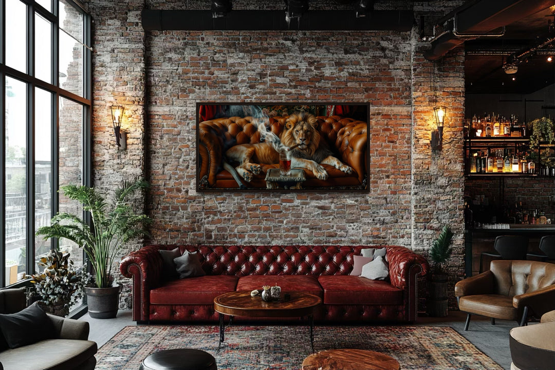 Lion on a couch smoking a cigar framed canvas print hanging on a brick wall in a man cave.