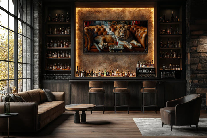 Lion on a couch smoking a cigar framed canvas print displayed in a modern home bar setting.