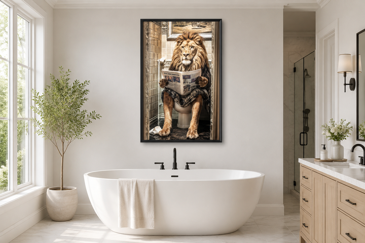 Framed canvas of a lion sitting on a toilet reading a newspaper, hung above a white bathtub.
