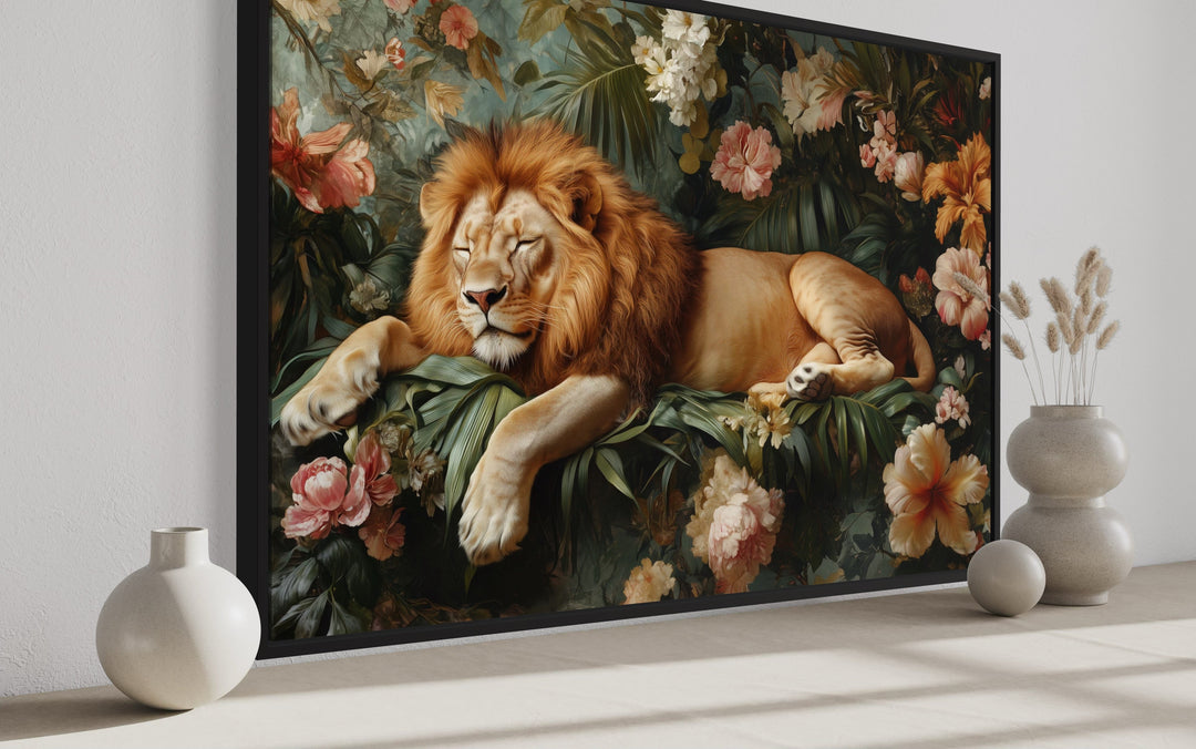 Framed canvas wall art of a lion sleeping among lush jungle flowers and greenery.
