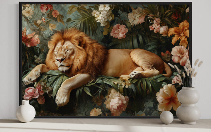 Framed canvas wall art of a lion sleeping among lush jungle flowers and greenery.