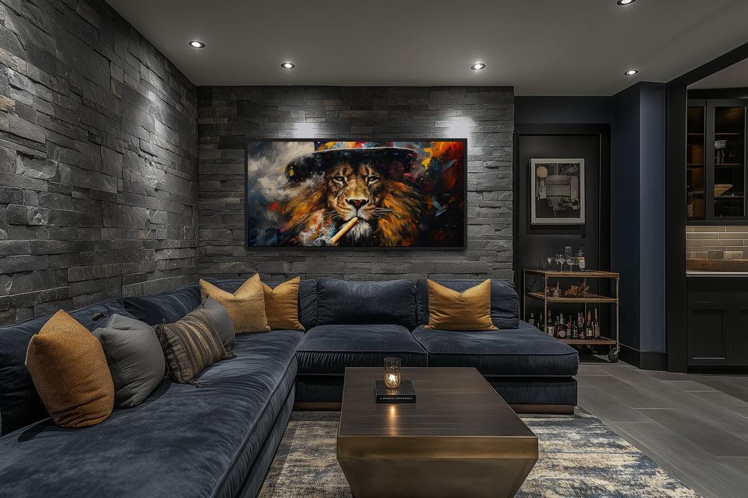 Framed canvas print of a lion smoking a cigar on a stone wall above a blue sectional sofa.