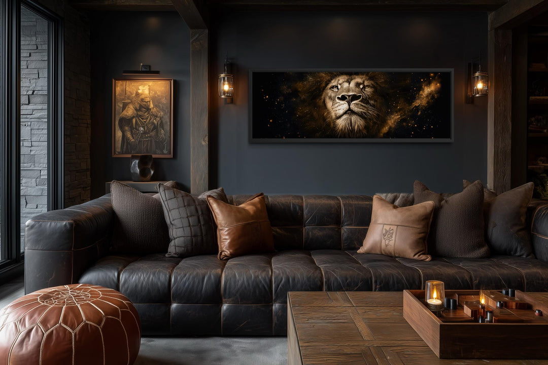 A long narrow canvas print of a majestic lion's face in black and gold hangs in a dark living room.