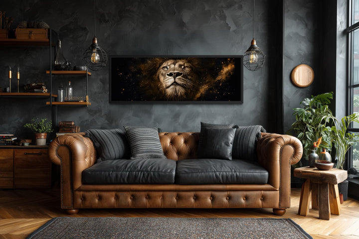 A long narrow canvas print of a majestic lion's face in black and gold above a leather sofa.