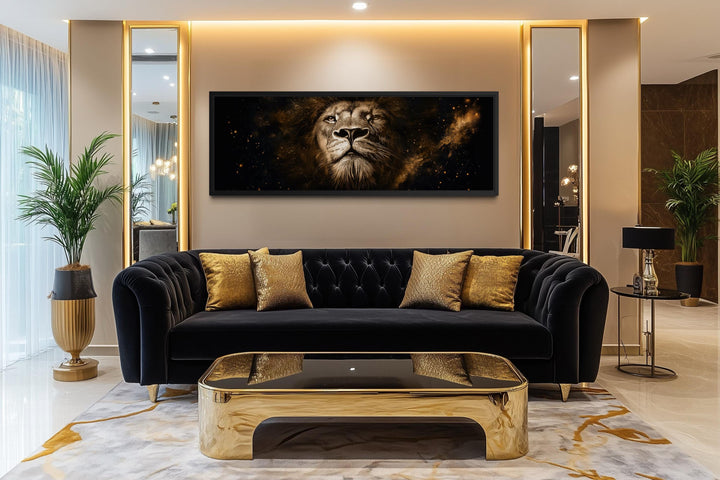 A long narrow canvas print of a majestic lion's face in black and gold above a modern sofa.